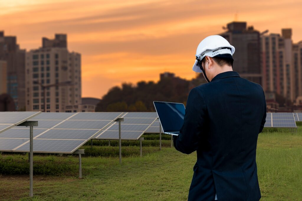 sustainable analysis - man looking at solar panels